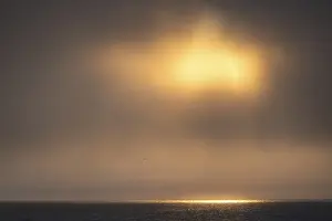 Norwegian Archipelago Prints: Sun breaking through clouds, reflection on sea surface