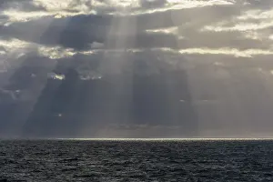 United Kingdom Coastal Views Prints: Sun breaks through the clouds with sunrays over sea