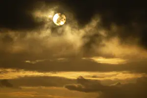 Cloudy Evening Sky Prints: Sun bursts out from behind clouds