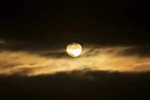 Atmospheric Evening Shot Prints: Sun between dark clouds, midnight sun