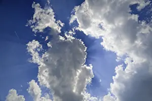 Cloud Formation Photography Prints: Sun hiding behind clouds in the sky