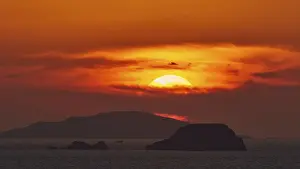 Greek Islands Sunset Prints: Sun setting behind the horizon