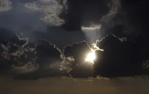 Stormy Sky Prints: Sun behind storm clouds