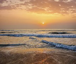 Tropical Evening Atmosphere Prints: Sunrise on beach with dramatic sky