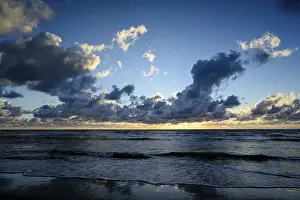 Deserted Dutch Coastline Prints: Sunset on the beach, with cloudy sky and surf