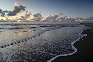 Deserted Dutch Coastline Prints: Sunset on the beach, with cloudy sky and surf