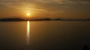 Southeast Europe Nature Scenes Prints: The sunset casts warm light over the still water