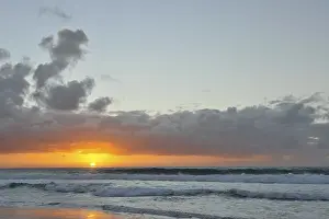 Evening Sun Over Water Prints: Sunset and clouded sky at the Atlantic Ocean