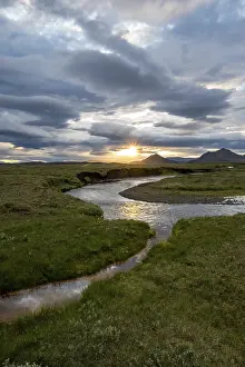Evening River Scene Prints: Sunset between clouds, river flowing through meadows