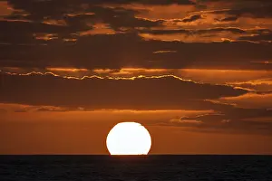 Evening Sun Africa Prints: Sunset with clouds, sun sinking into the sea