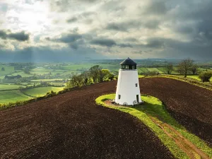 Agricultural Landscape From Above Prints: Sunset of Devon Windmill over Fields and Farms from a drone