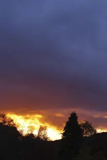 Evening Sun Silhouette Prints: Sunset with dramitic dark clouds