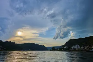 Dramatic Clouds Germany Prints: Sunset over a river with dramatic clouds and hills on the horizon