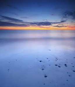 Evening Atmosphere Coastal Scene Prints: Sunset at the sandy beach with pebbles