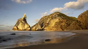 Evening Light Atmosphere Photo Prints: Sunset on sandy beach with rocks
