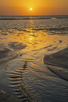 Evening Light On Sandy Beach Prints: Sunset over tidal creek on sandy beach