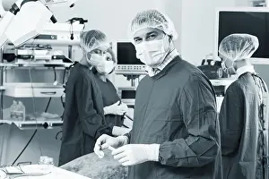 Medical Care Worker Prints: Surgeon looking at camera with colleagues