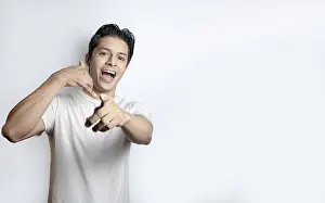 White Background Portrait Photo Prints: Surprised man gesturing call me on white background