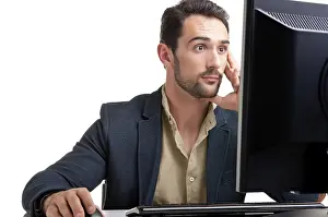 Self Confident Man Prints: Surprised man looking at a computer screen