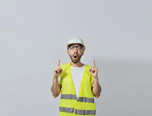 Empty Space Symbolism Prints: Surprised young architect pointing up