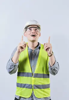 Building Industry Prints: Surprised young architect pointing up