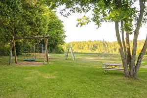 Agricultural Landscape Germany Prints: A swing and a table in a green clearing with a view of fields