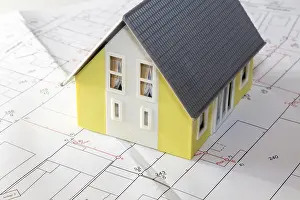 Residential Building Plans Prints: Symbolic image of building: Model house on a development plan