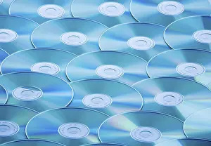 Data Backup Solutions Prints: A table full of CD-ROMs and DVDs