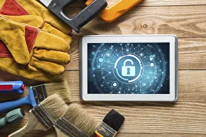 Industrial Tools Around Computer Prints: Tablet pc with security concept on screen and industrial tools around