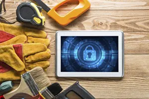 Tablet Pc Security Concept Prints: Tablet pc with security concept on screen and industrial tools around