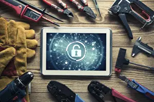 Tablet Pc Security Concept Prints: Tablet pc with security concept on screen and industrial tools around