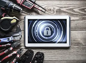 Handicraft Symbolism Prints: Tablet pc with security concept on screen and industrial tools around