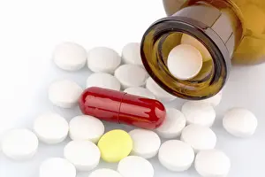 European Healthcare System Prints: Many tablets with container. Lying on a white background Austria