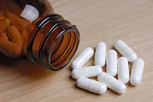 Healthcare System Treatment Prints: Tablets lying in front of a bottle