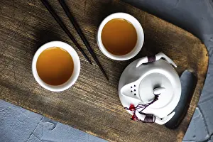 Empty Room For Text Prints: Teapot and cupd with tea on rustic background with copy space