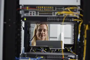 Server Room Technician Prints: Technician examining server in server room