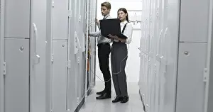 Healthcare Network Prints: Technicians using laptop while analyzing server in server room
