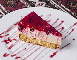 White Tablecloth Prints: Tempting slice of raspberry cheesecake with syrup on a white plate
