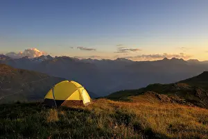 Evening Sun In Austria Prints: Tent in front of a mountain range in the last daylight