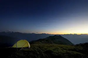 Austrian Mountain Landscape Prints: Tent in front of a mountain range in the last daylight