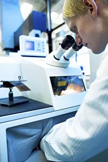 Microscope Examination Prints: Testing of material man at a circuit board welding machine