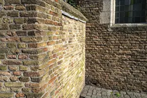 Deserted Brick Structure Prints: Texture-rich brick wall in the shade with clearly visible patterns