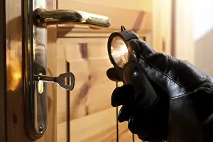 Deserted Castle Entrance Prints: Thief using a flashlight to examine a door lock