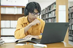 Laptop Learning Prints: Thoughtful Young Student Preparing for Class
