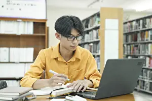 Education System Prints: Thoughtful Young Student Preparing for Class