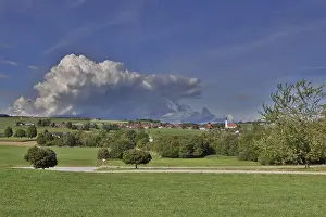 Village In The Alps Prints: Threatening thundercloud over a sunny
