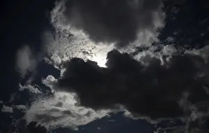 Cloudy Atmospheric Conditions Prints: Thundercloud pushes in front of the sun
