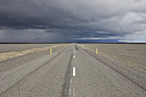 Cloudy Day In Iceland Prints: Thunderclouds forming over a highway