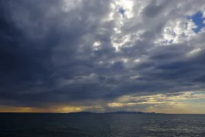 Evening Light In Italy Prints: Thunderclouds at sunset on the beach