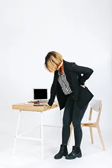 Tired Businesswoman Prints: Tired office worker having spine problem
